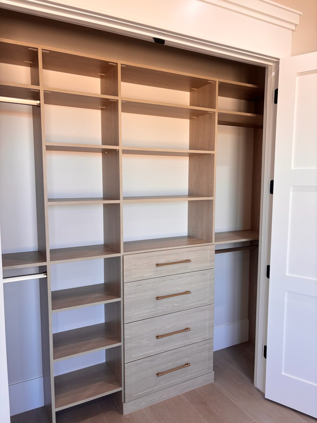 Reach-in closet with oak shelving and drawers