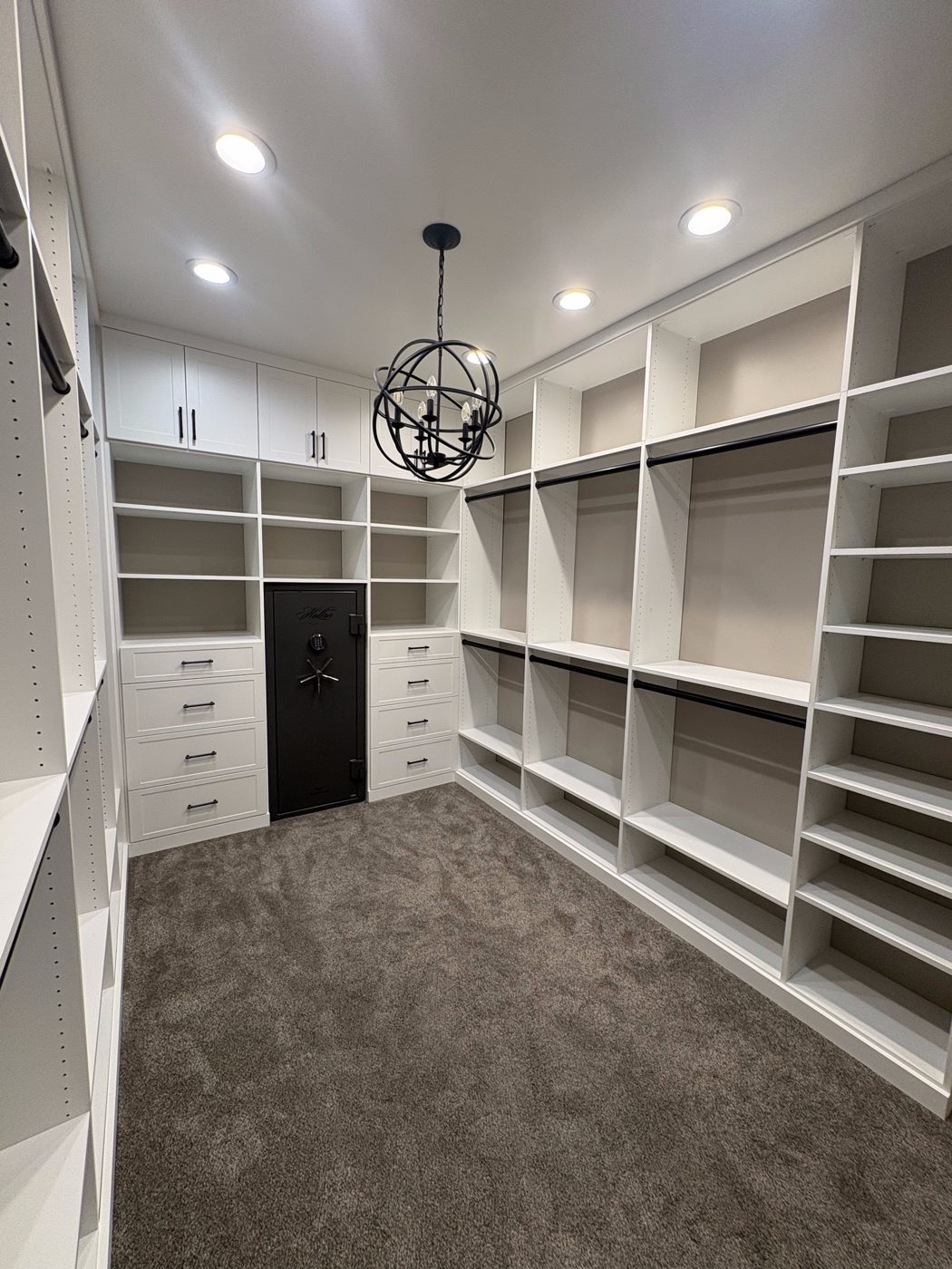 White walk-in closet with chandelier