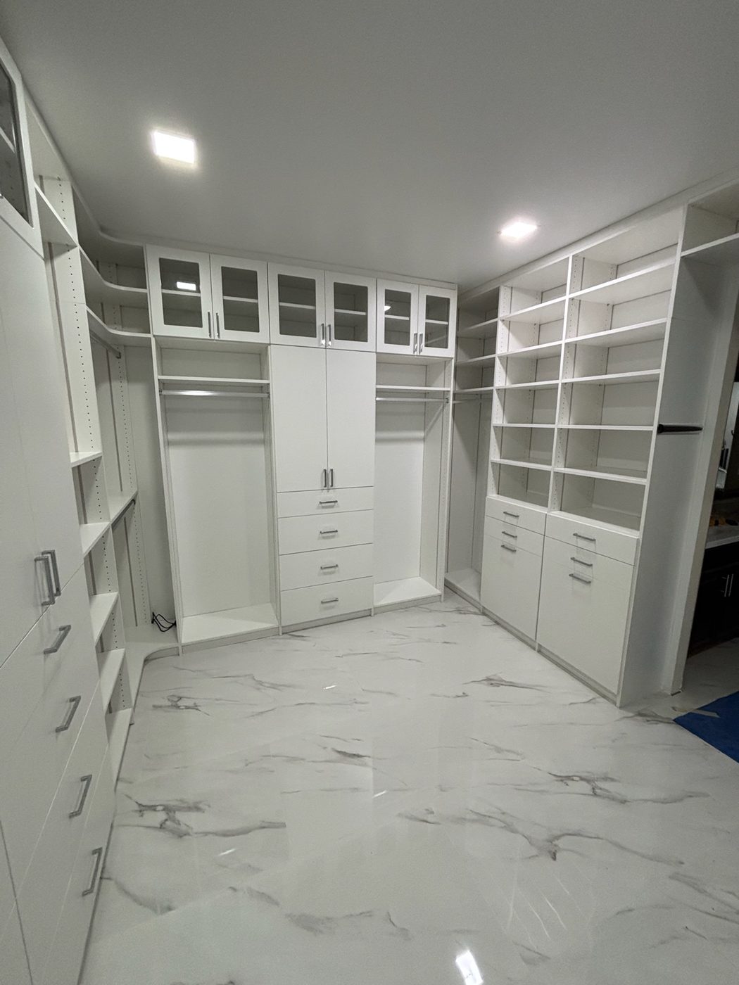 White walk-in closet on marble tile